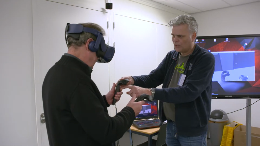 Person being given VR controllers